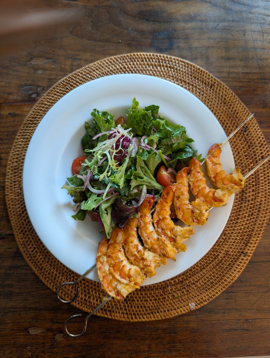 Grilled shrimp skewers with salad