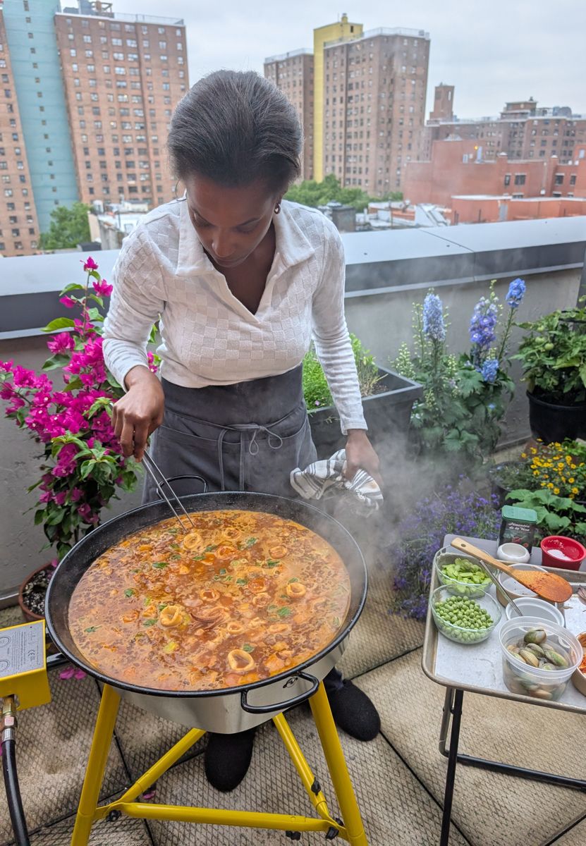 Chef Franchesca cooking paella on a New York rooftop